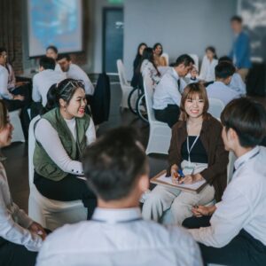 Team building, Asian workshop participants in small group discussion, brainstorming during business workshop class